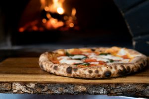 pizza on brown wooden table naples