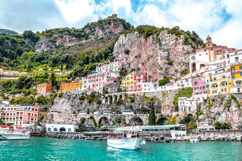 white boat on body of water near amalfi port