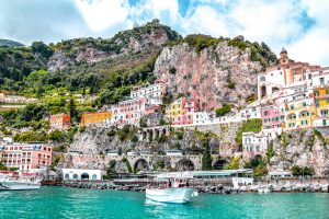 white boat on body of water near amalfi port