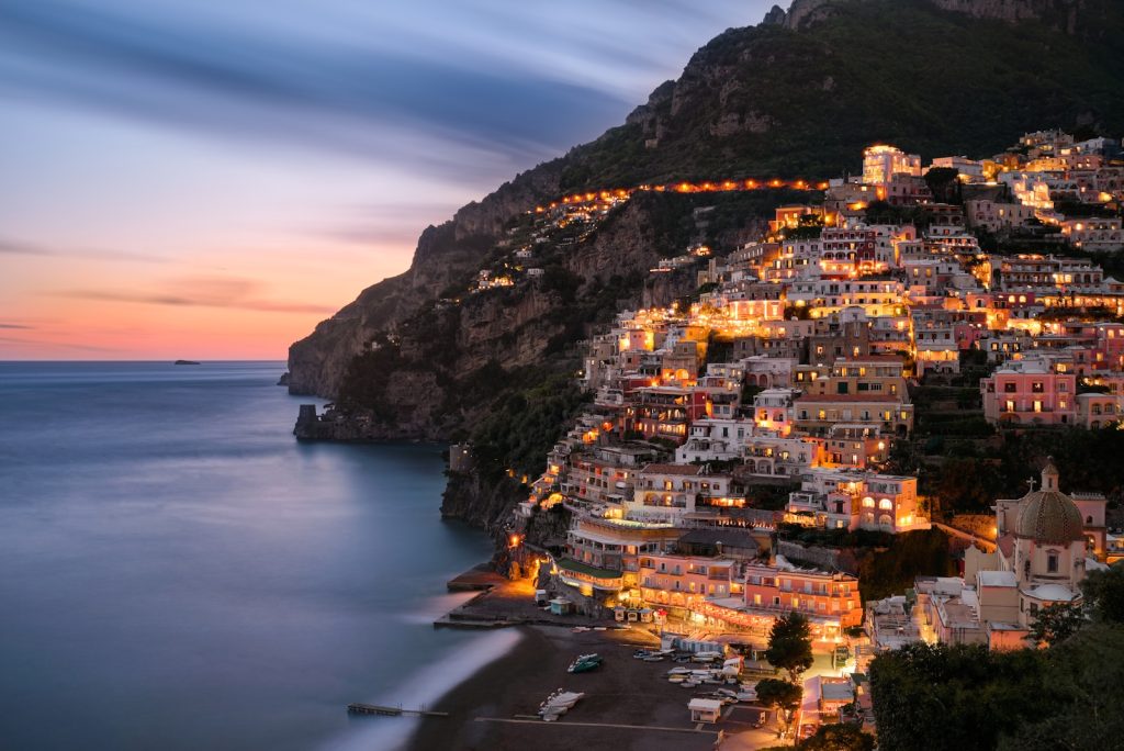 city buildings on mountain near body of amalfi coast