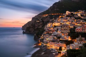 city buildings on mountain near body of amalfi coast